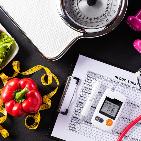 World health day, Healthcare and medical concept. Healthy food including fresh fruits, vegetables, weight scale, sports shoes, dumbells and measure tape on black background