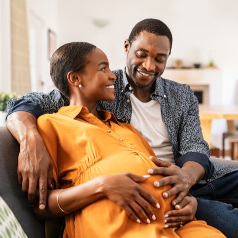 Happy loving pregnant black couple