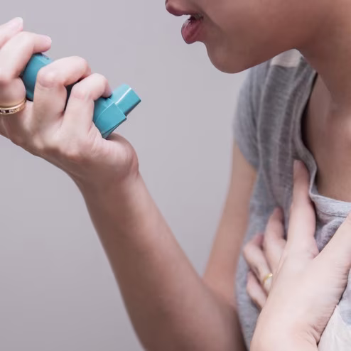 Woman Using Inhaler for COPD Relief