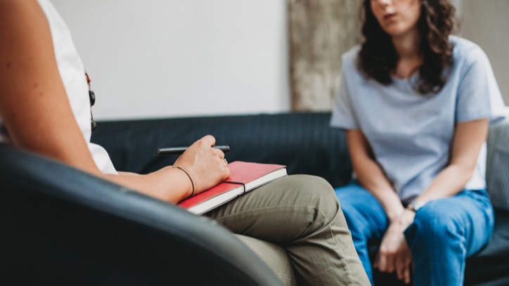 Psychotherapy session, woman talking to his psychologist in the studio