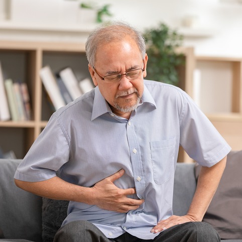 Senior Experiencing Abdominal Pain at Home