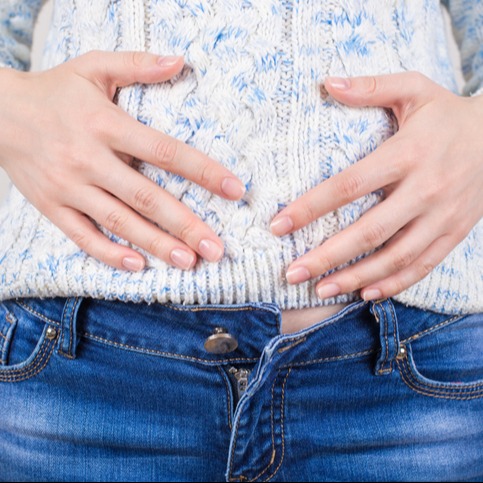 Woman Experiencing Stomach Cramps After Eating