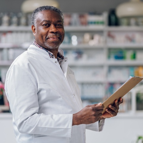 Portrait of a happy African-American senior pharmacy owner 