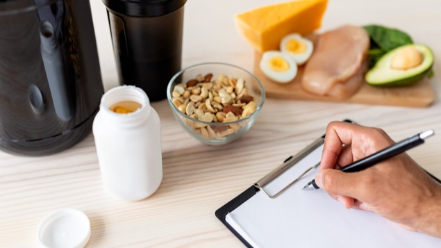 Closeup of senior bodybuilder writing meal plan