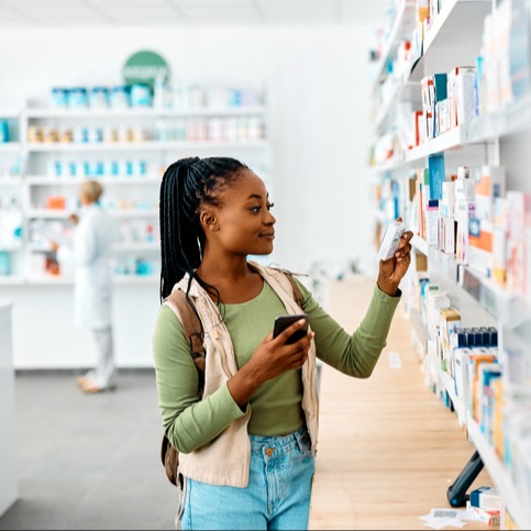 Young black woman buying medicines in a pharmacy