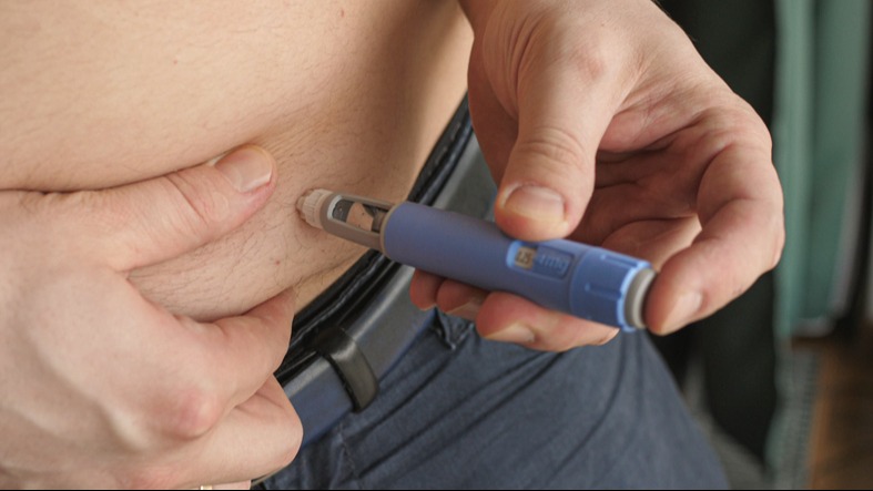 Obese fat man injecting Semaglutide injection control blood sugar levels