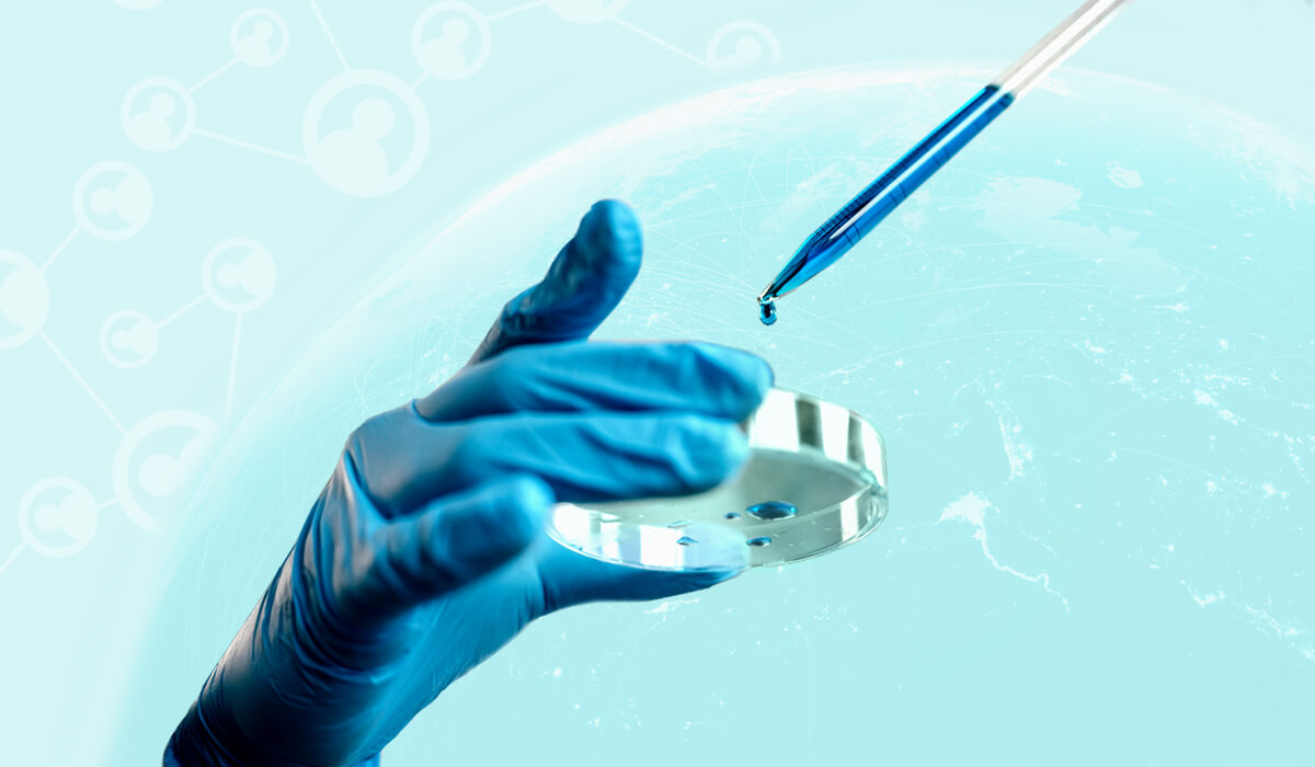 A hand grasping a blue glove and a blue pen, symbolizing Sanofi's HR transformation.