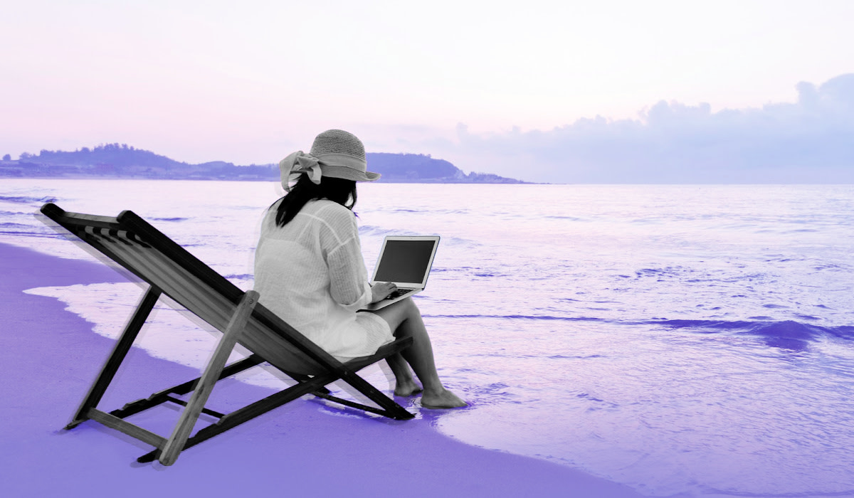 Woman with laptop on beach