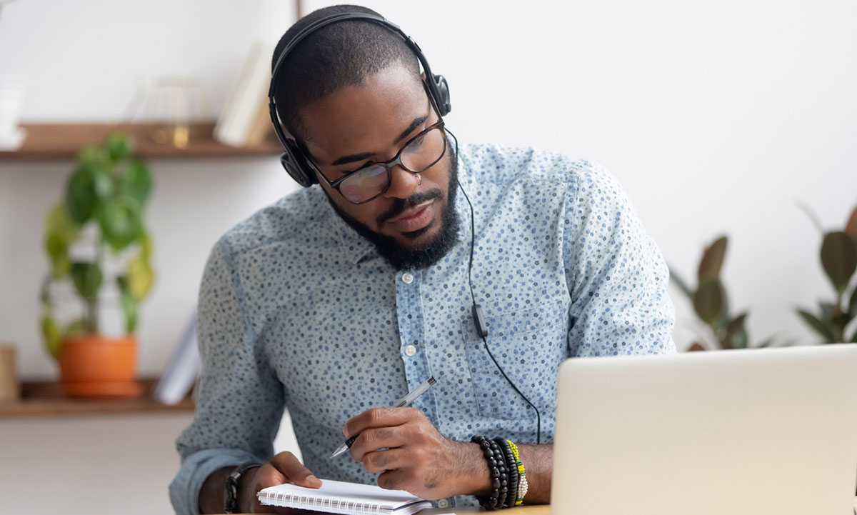 HR business partner sitting at his desk looking at laptop and assessing data