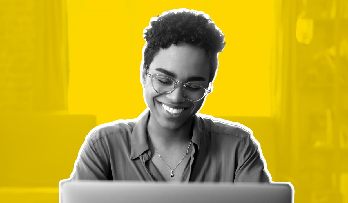 Woman looking at computer smiling
