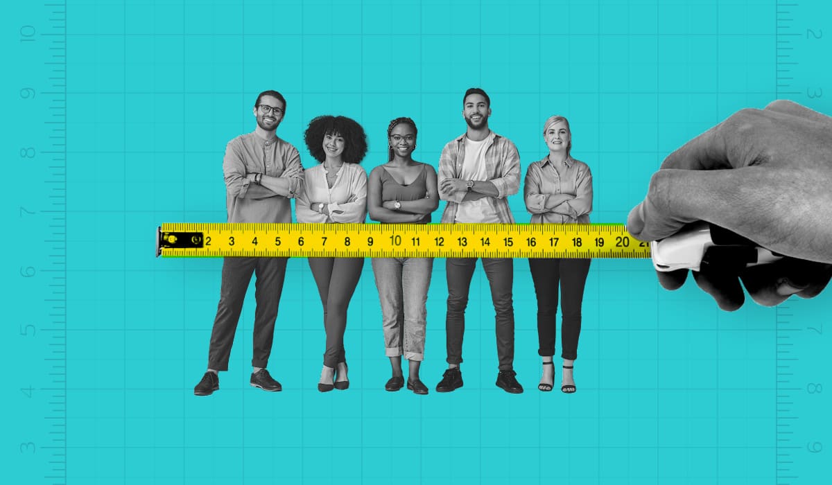 Five employees standing in a row with a hand holding a tape measure in front of them.