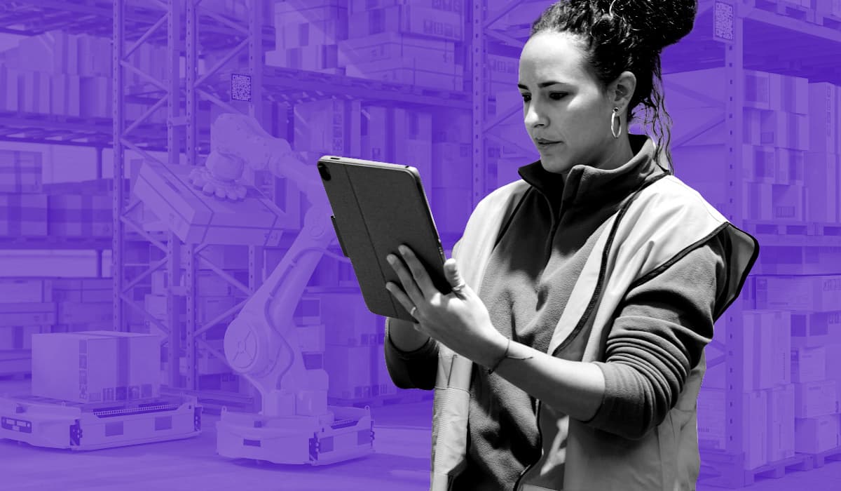 Woman using iPad in a shipping warehouse