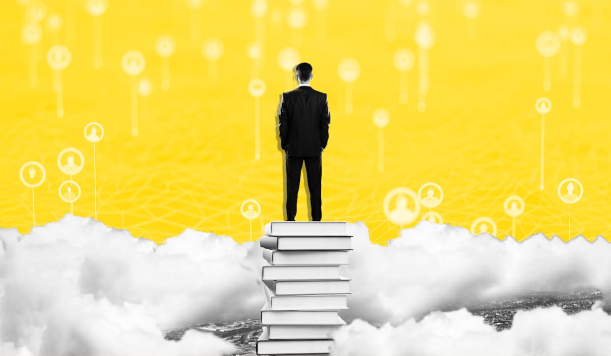 Man standing on a stack of books surrounded by clouds looking at people data