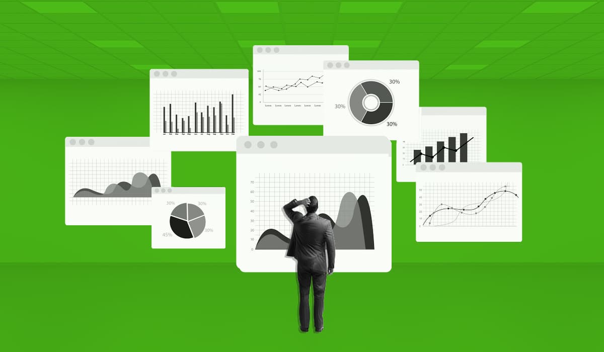 Man looking at a series of screen with charts and graphs showing reports and analytics
