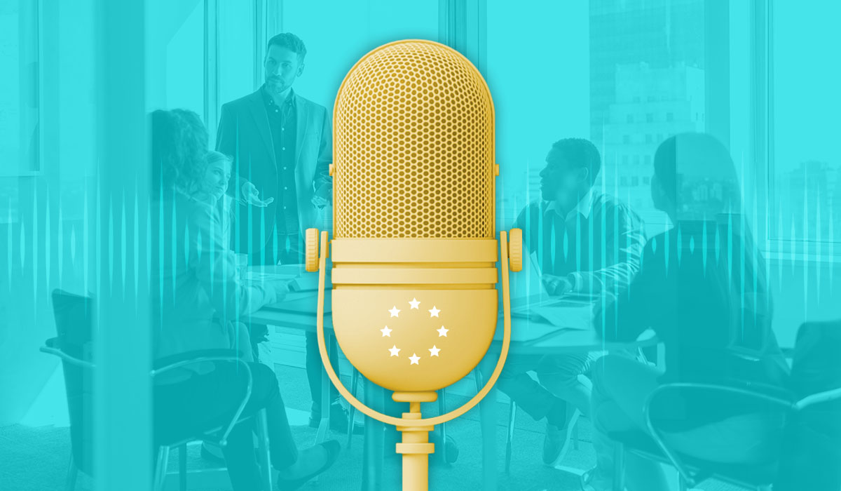 Microphone with EU symbol in front of C-level executives talking in an office, representing the increased transparency to come with the EU CSRD reporting requirements.