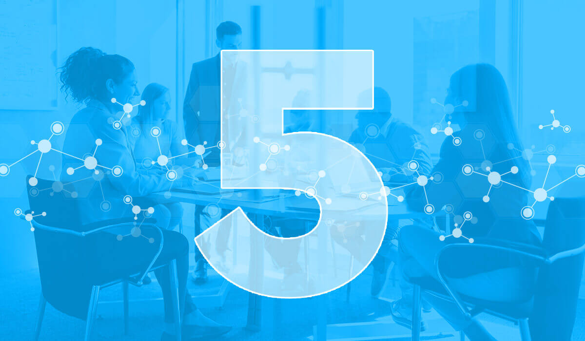 A group of employees seated at a table with a blue overlay and the number 5, representing the 5 HR analytics examples featured in this article.