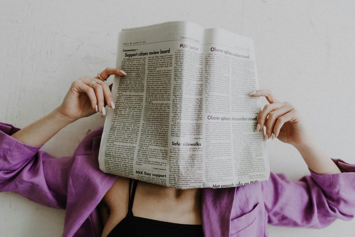 Photo by Leah Newhouse: https://www.pexels.com/photo/unrecognizable-woman-covering-face-with-newspaper-11664907/