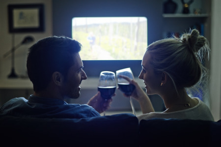 Couple enjoying wine and a movie night