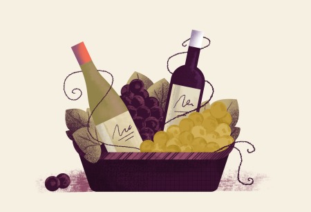 Wine basket with different type of wines and grapes