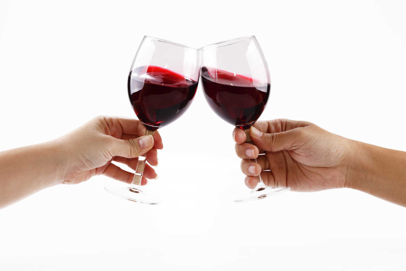 Toasting with two glasses of red wine
