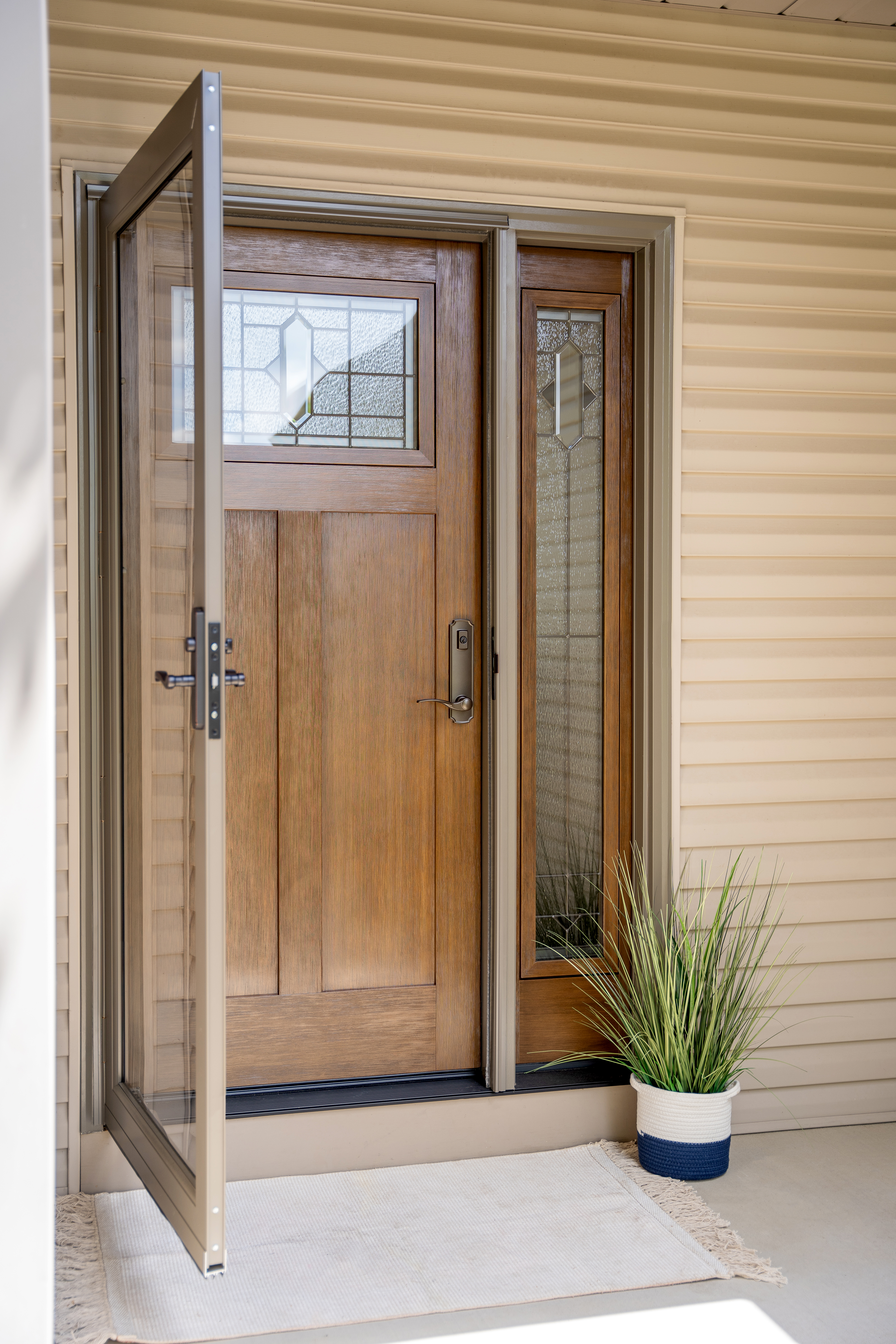 A large wooden entryway with a glass storm door.