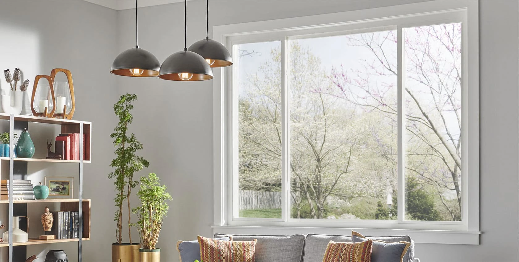 An interior view of a wide sliding window with a white frame. 