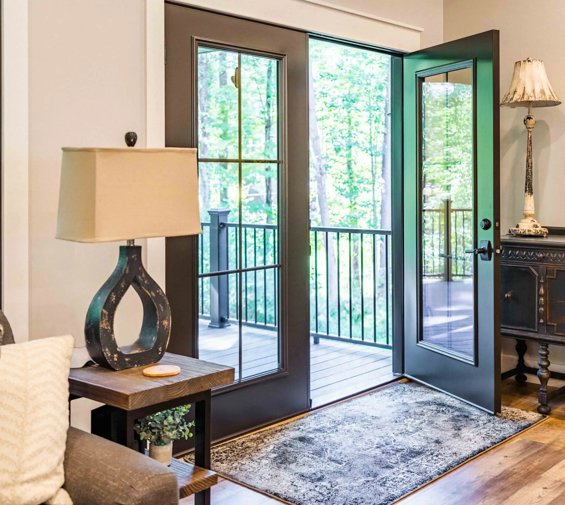 Large french doors with a decorated interior opening to a large deck.