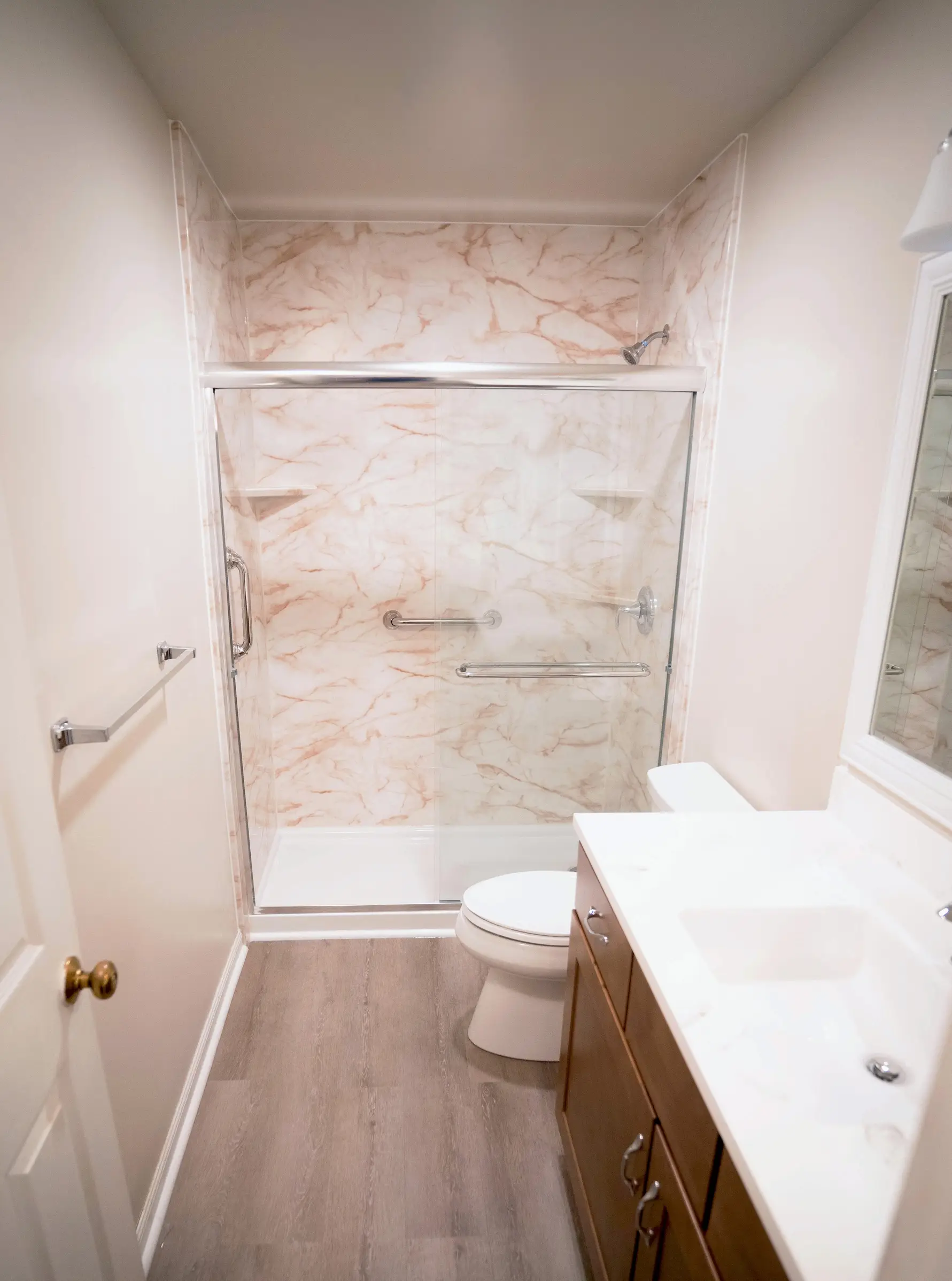 Full bathroom remodeling project including walk-in shower, vanities, toilets, flooring, and more.