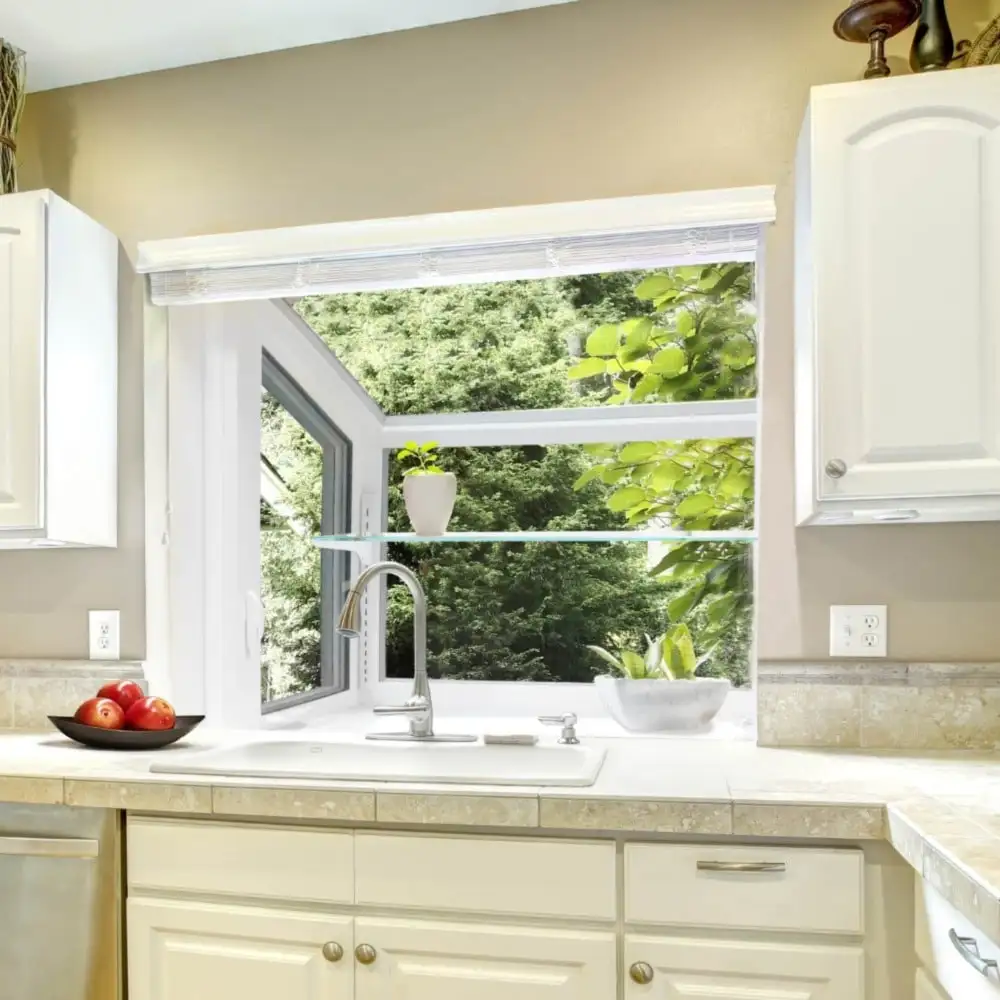 A large garden window in a brightly-lit kitchen.