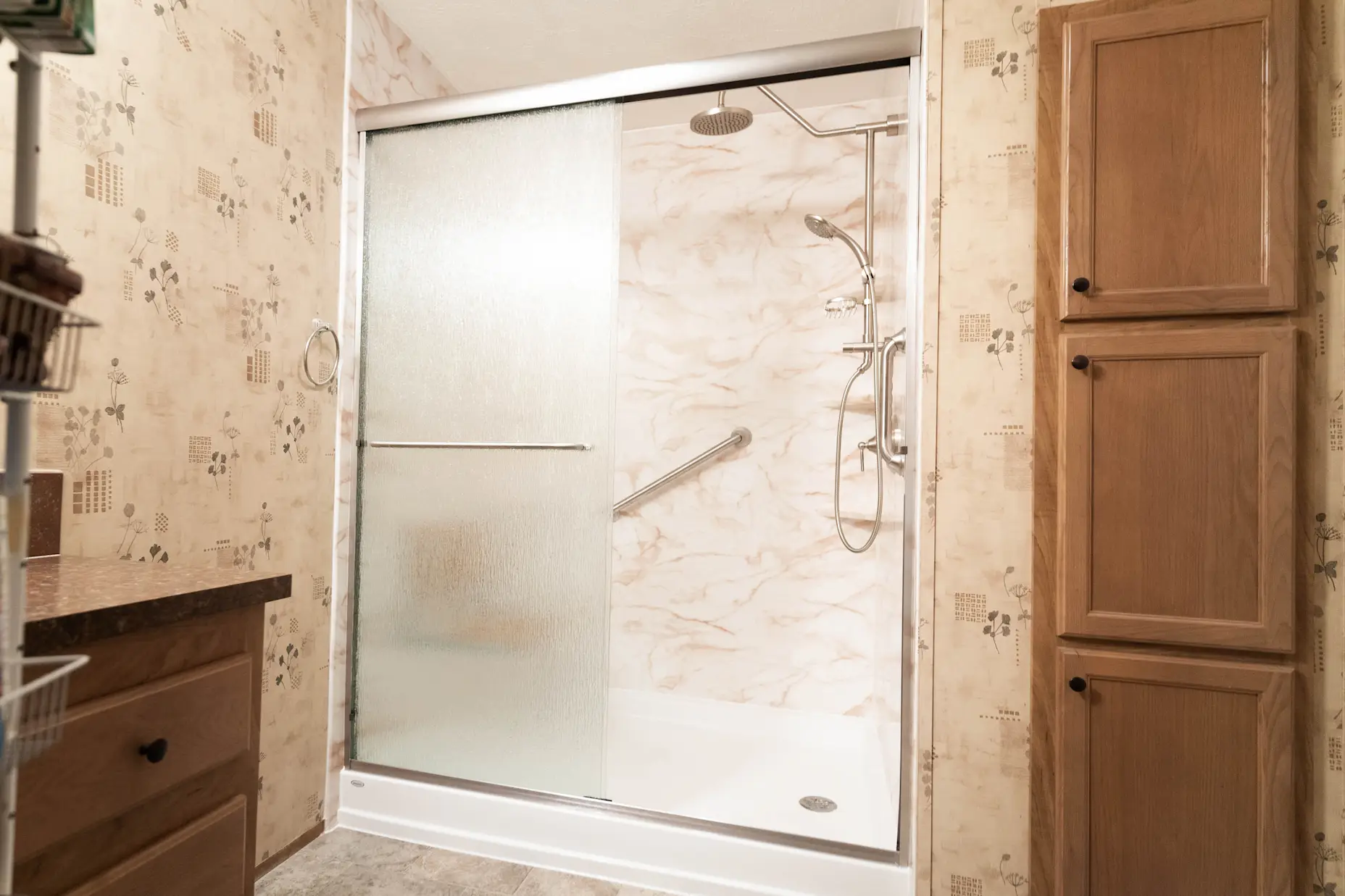 A new walk-in shower installation featuring an opaque sliding glass shower door.