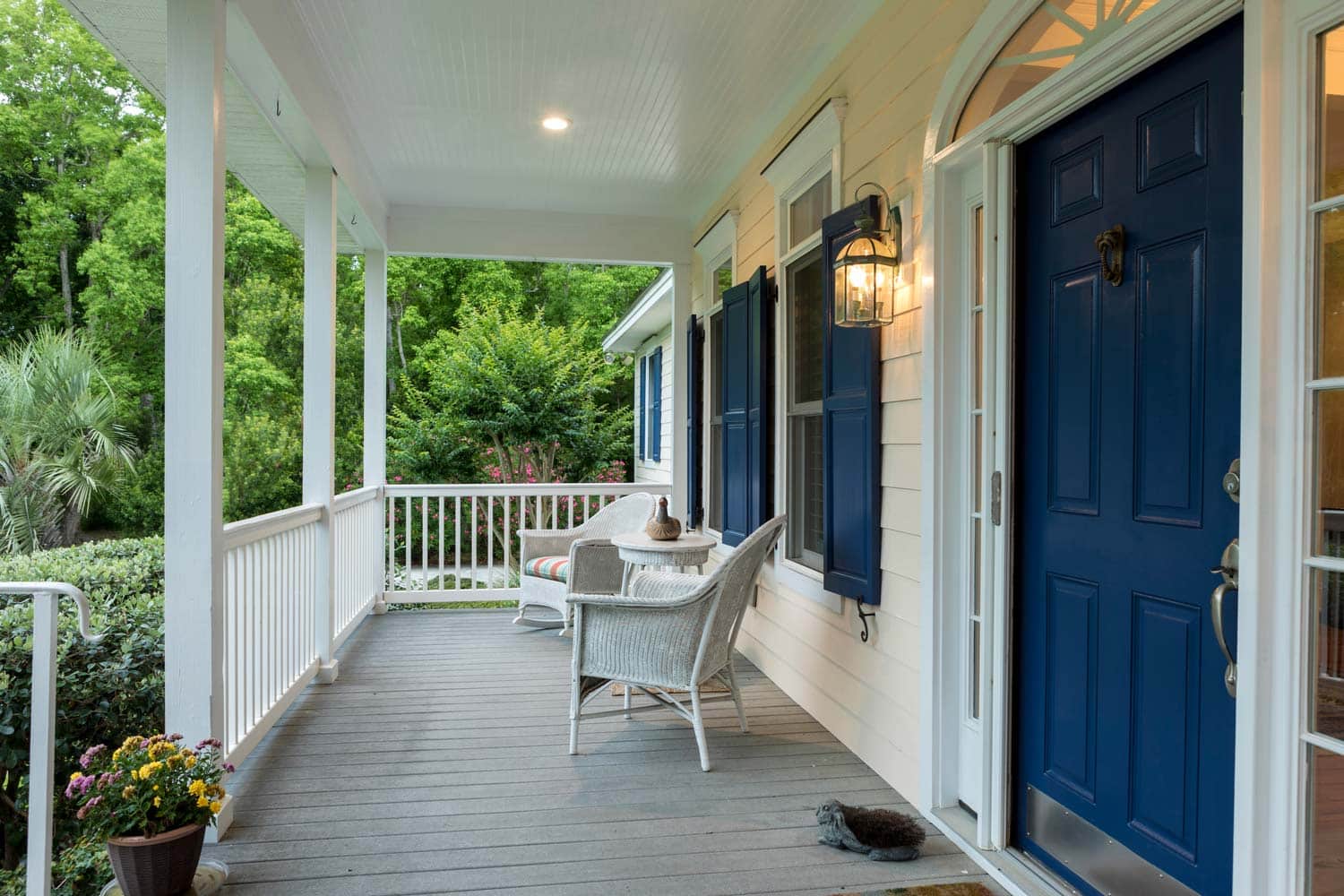 A large hoem with a spacious front porch.