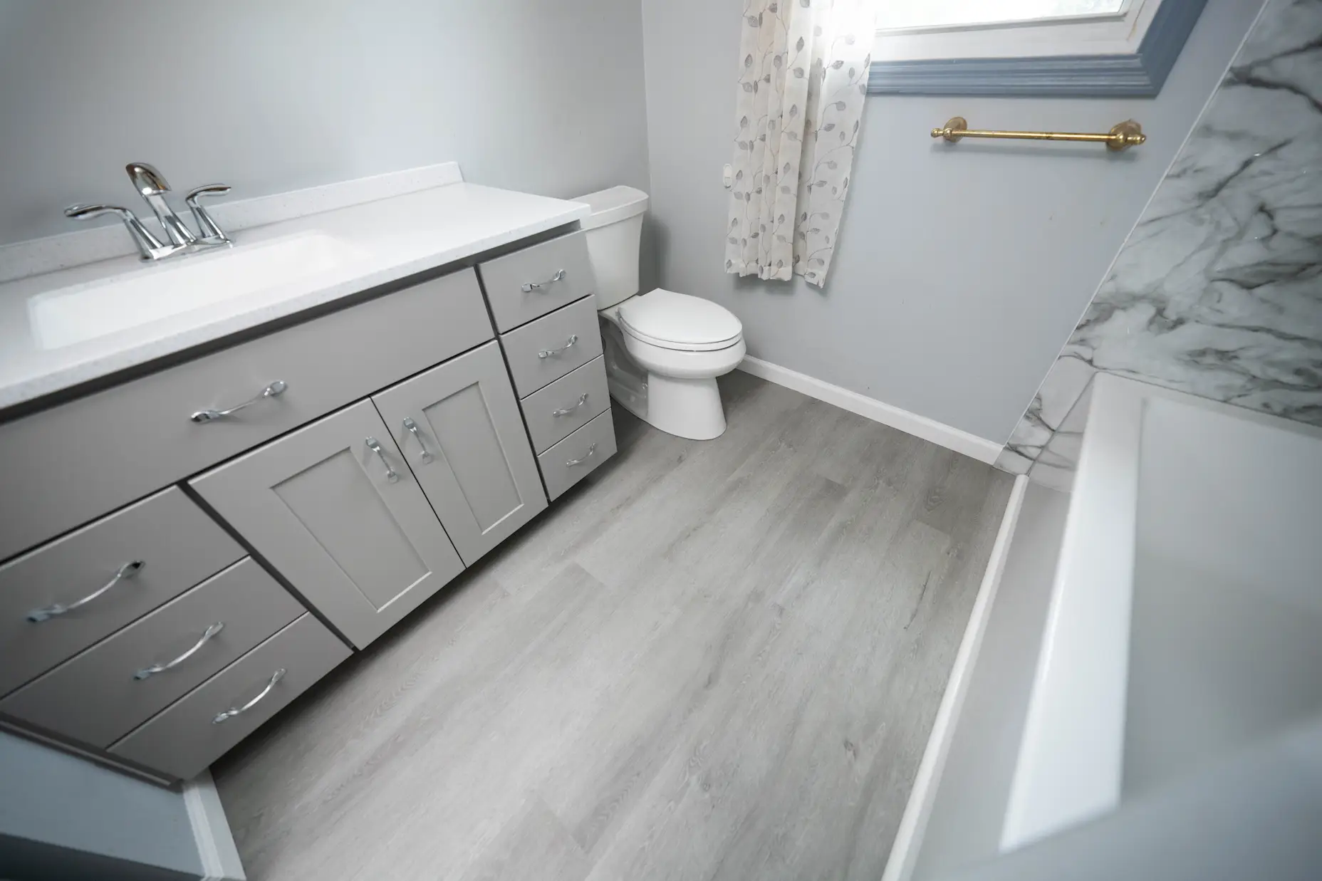 A new West Shore Home full bathroom remodel featuring Mist Wood flooring.