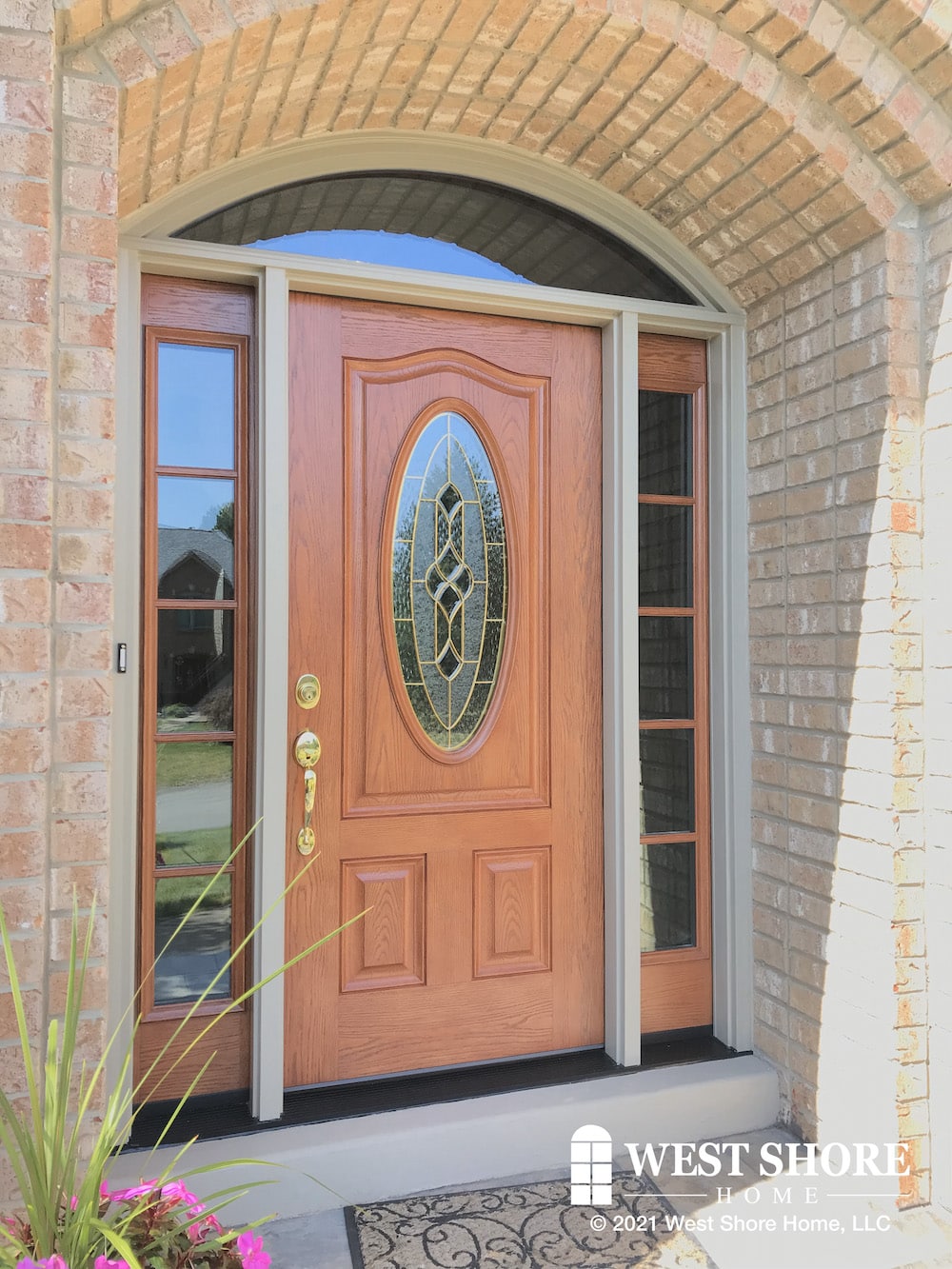 An arched brick entryway with a large wooden door.