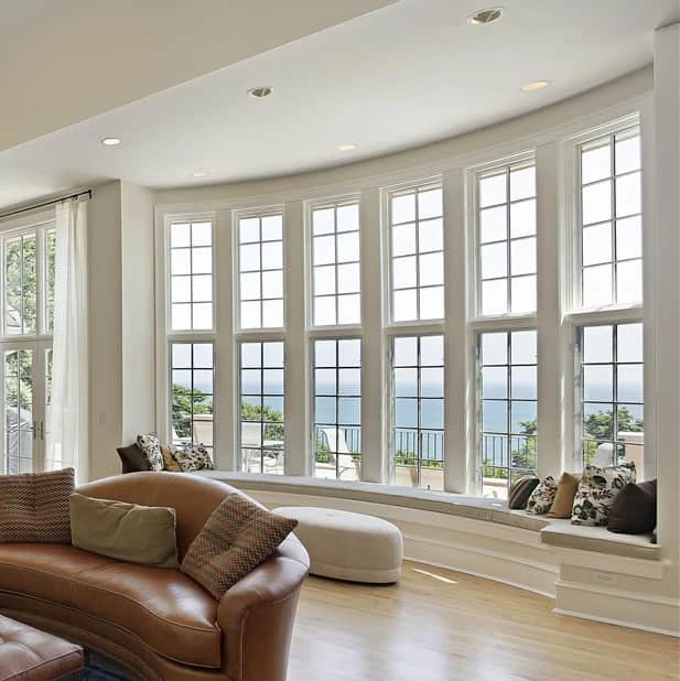 A large bank of bow windows overlooking a seascape.