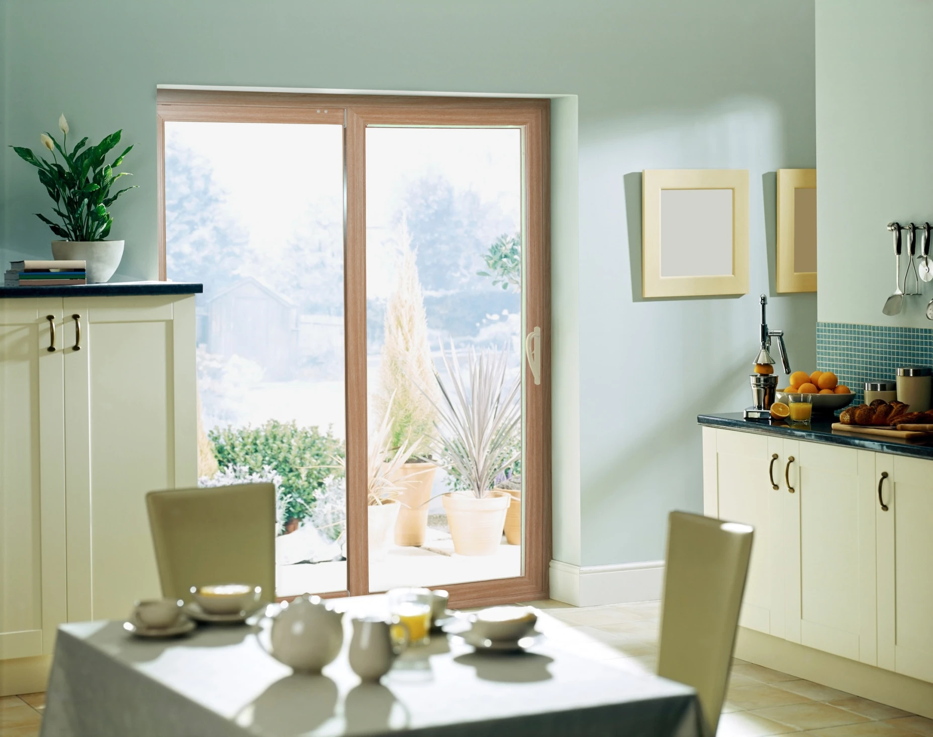 A sliding glass door with a wooden frame as seen from a contemporary kitchen interior.