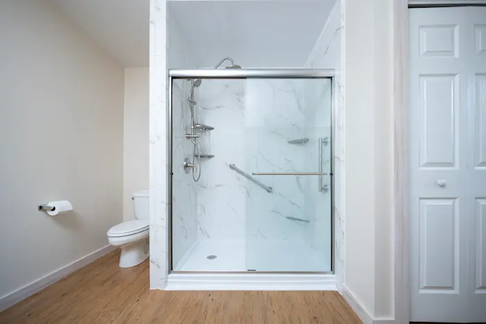 Spa-style remodeled bathroom with warm marble-look walls