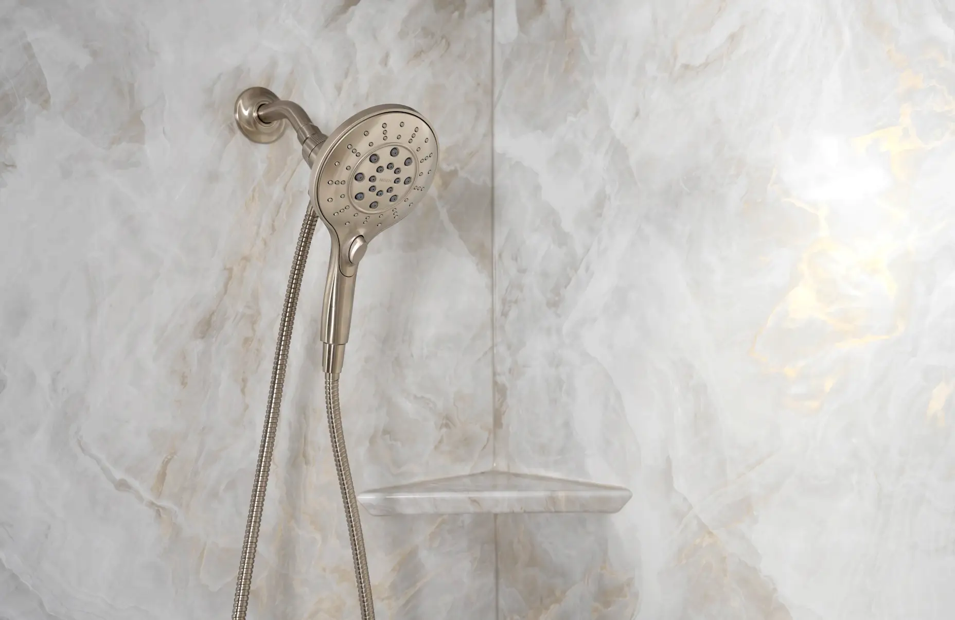 A neutral, marble-design acrylic shower wall with brushed nickel shower head