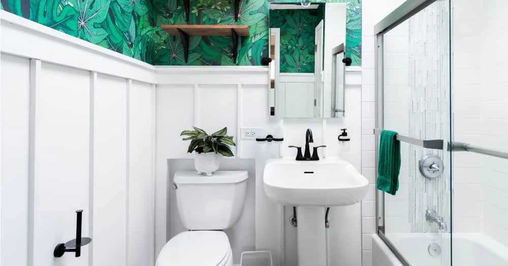 A luxurious small bathroom with a green and white color scheme.