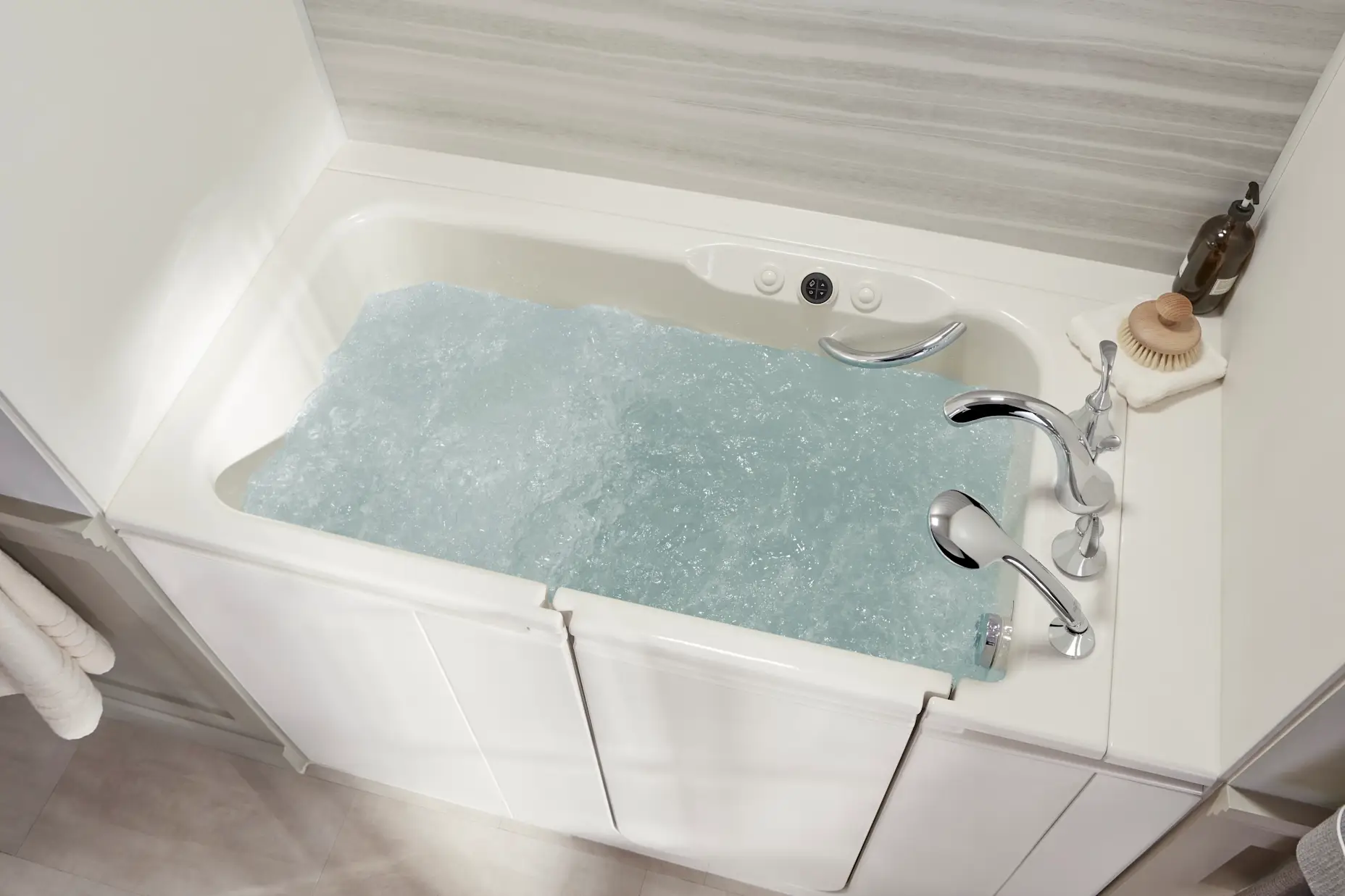 A top view of a white walk-in tub with jets and chrome accessories.