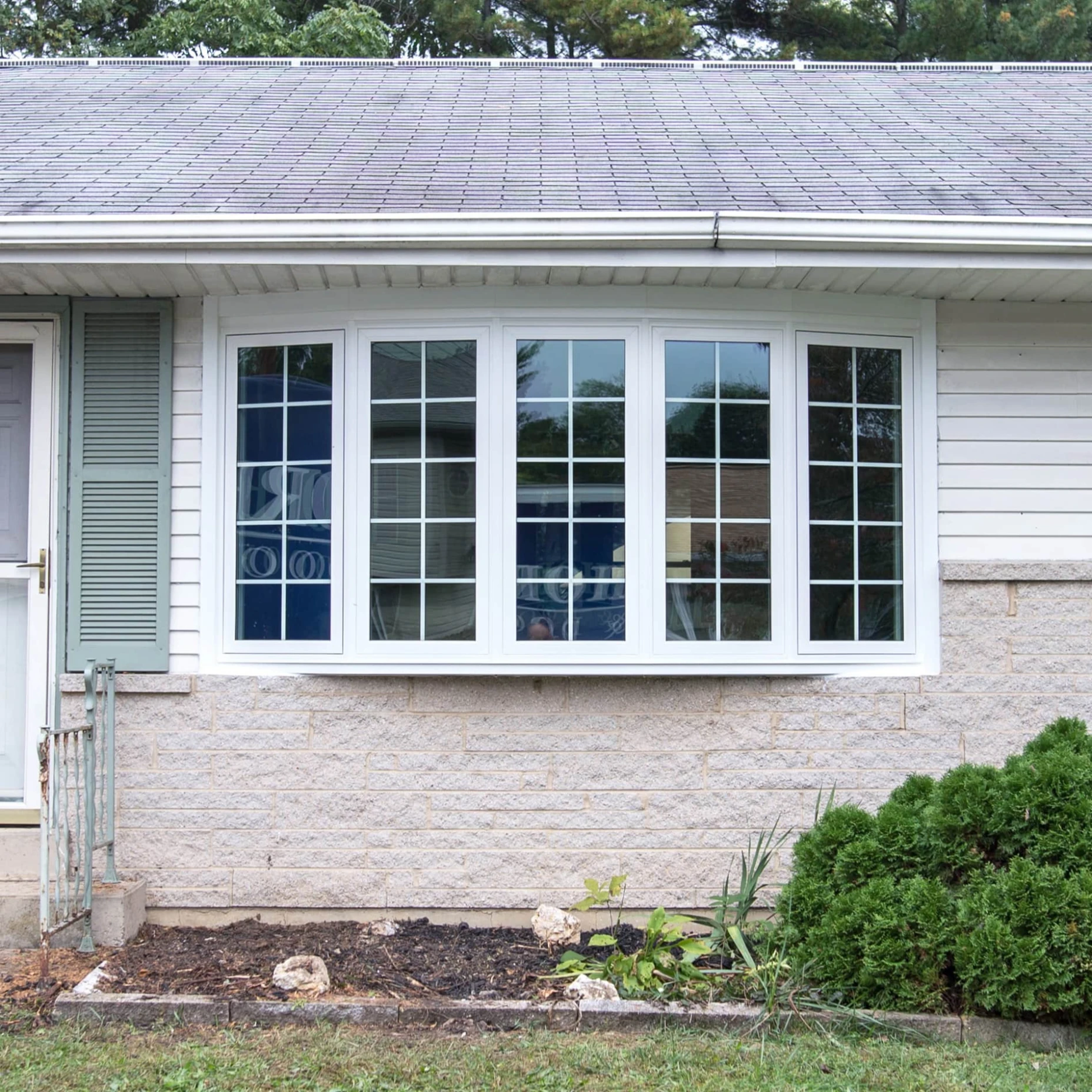 An exterior shot of a large row of bow windows.