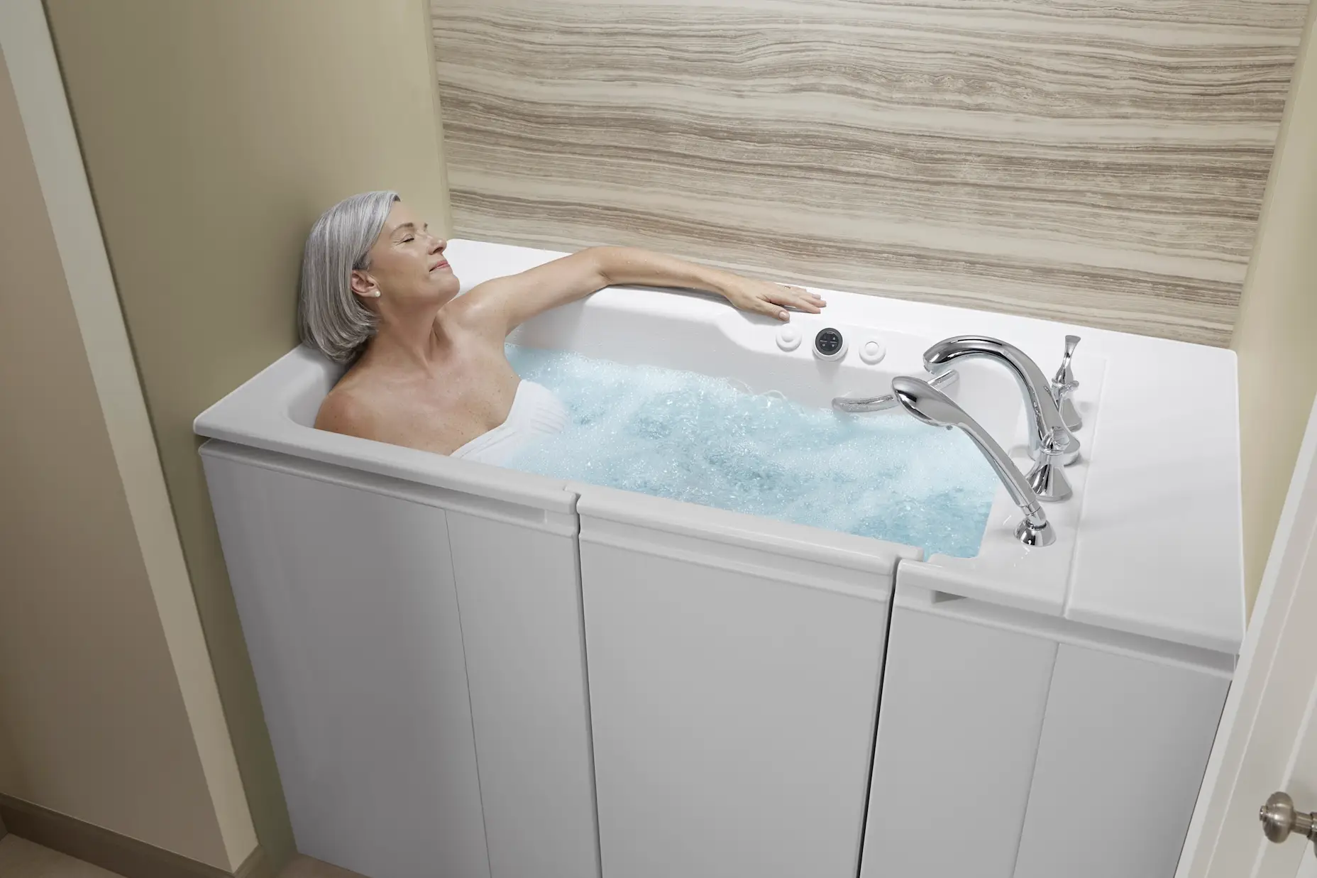 A woman soaking in a walk-in tub.