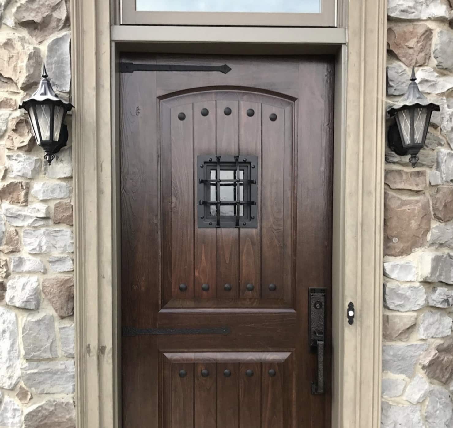 A rustic front door in a stone entryway.