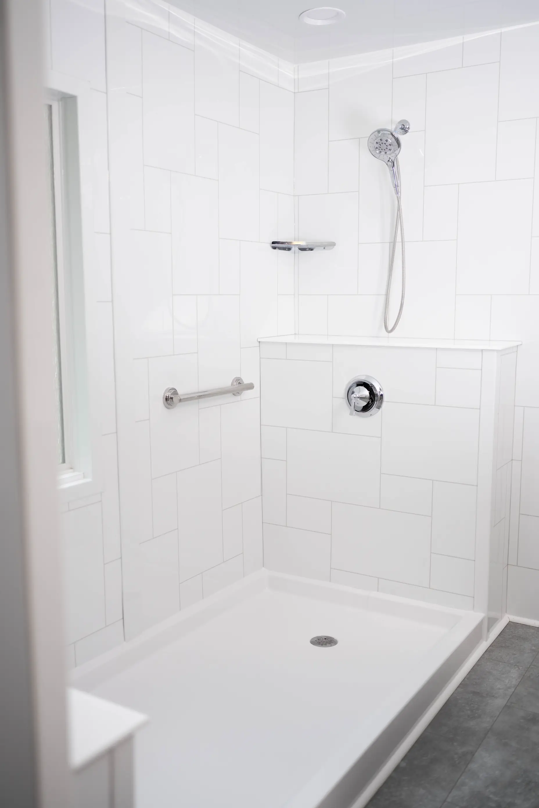 An all-white full bathroom remodel installation from West Shore Home.