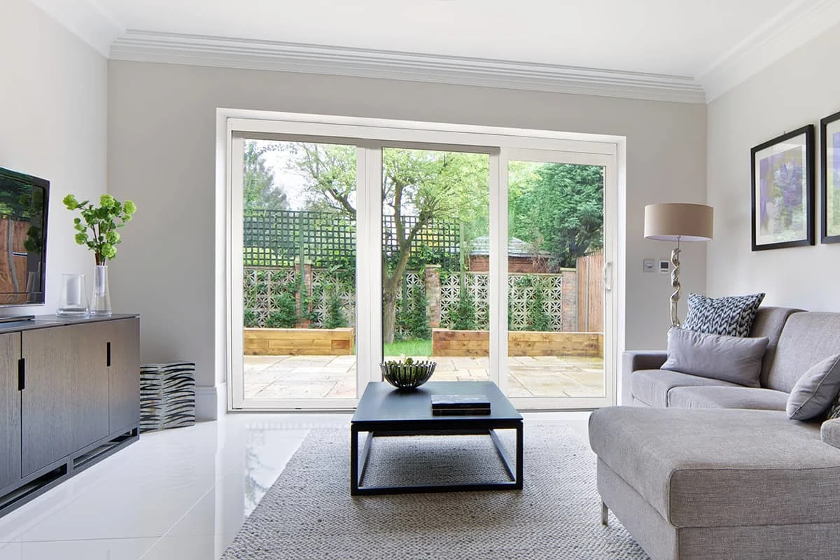 White sliding glass patio doors as seen from a spacious living room.