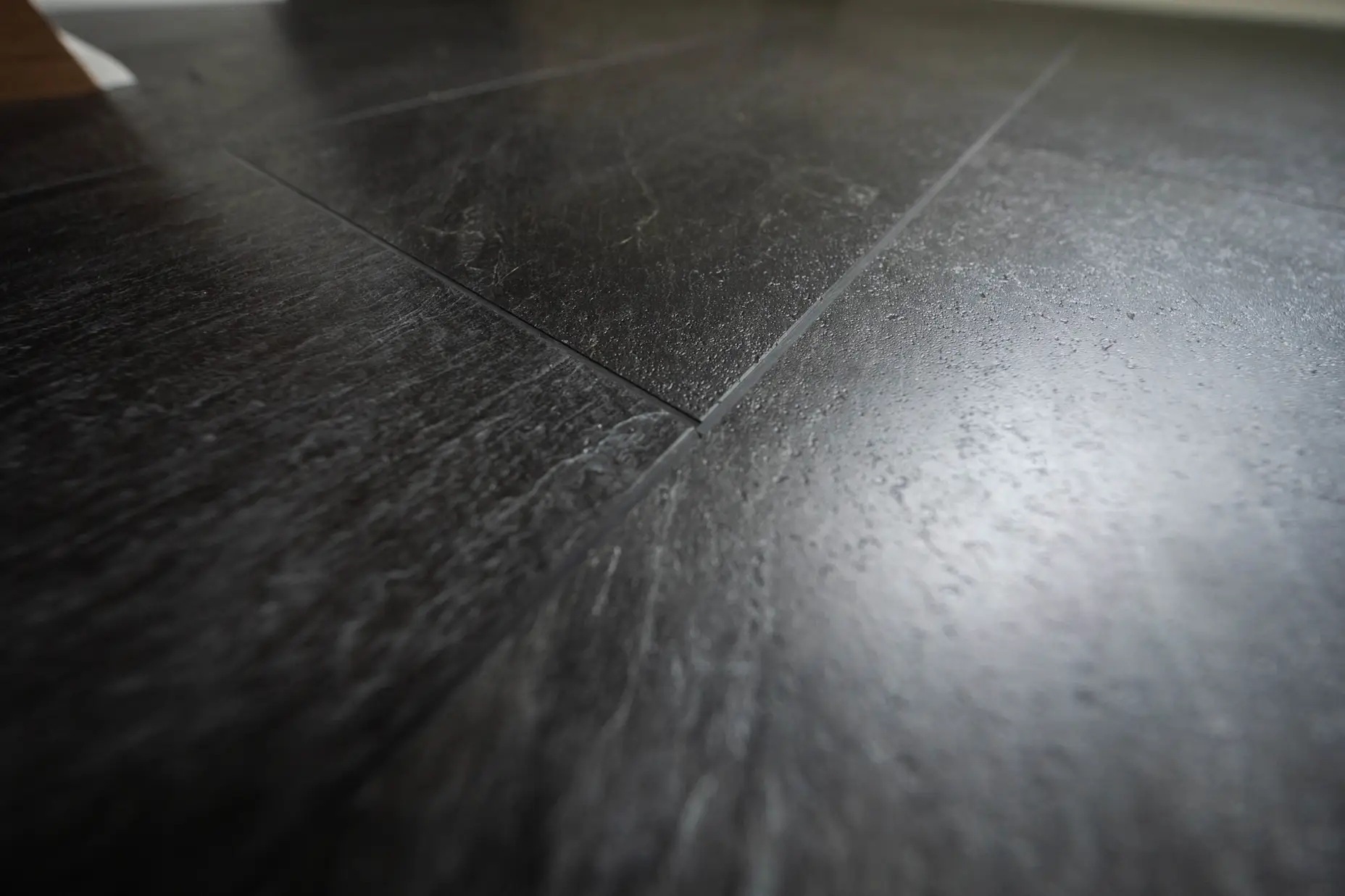 Close up image of black tile flooring.