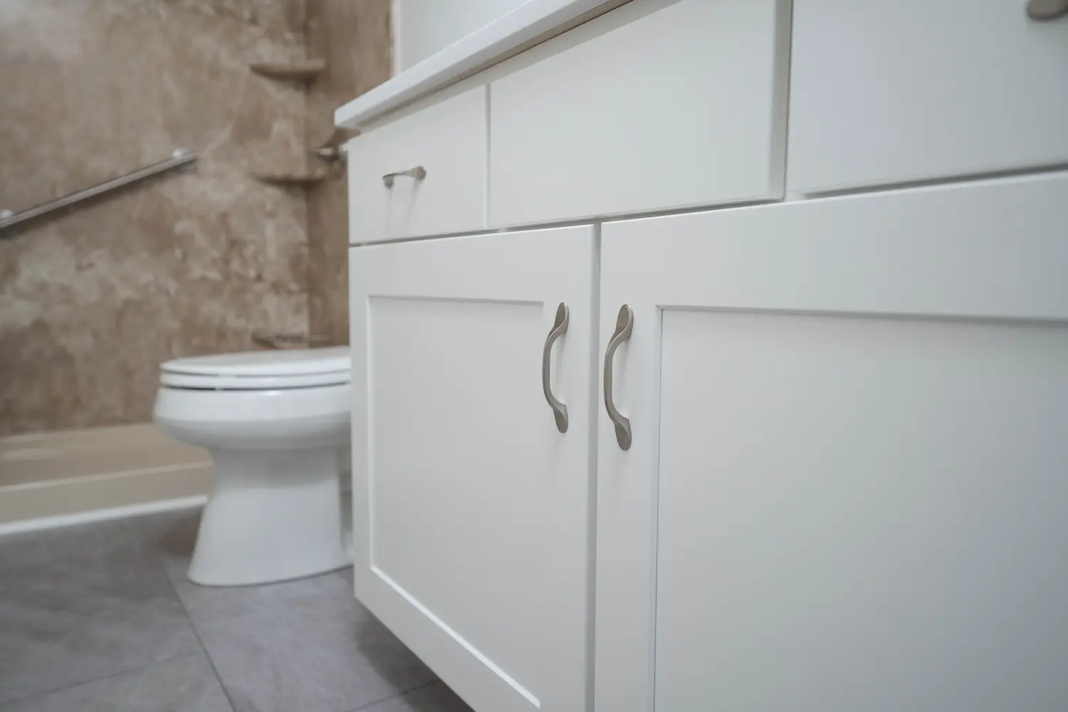 A white vanity in a newly completed full bathroom remodeling project from West Shore Home.