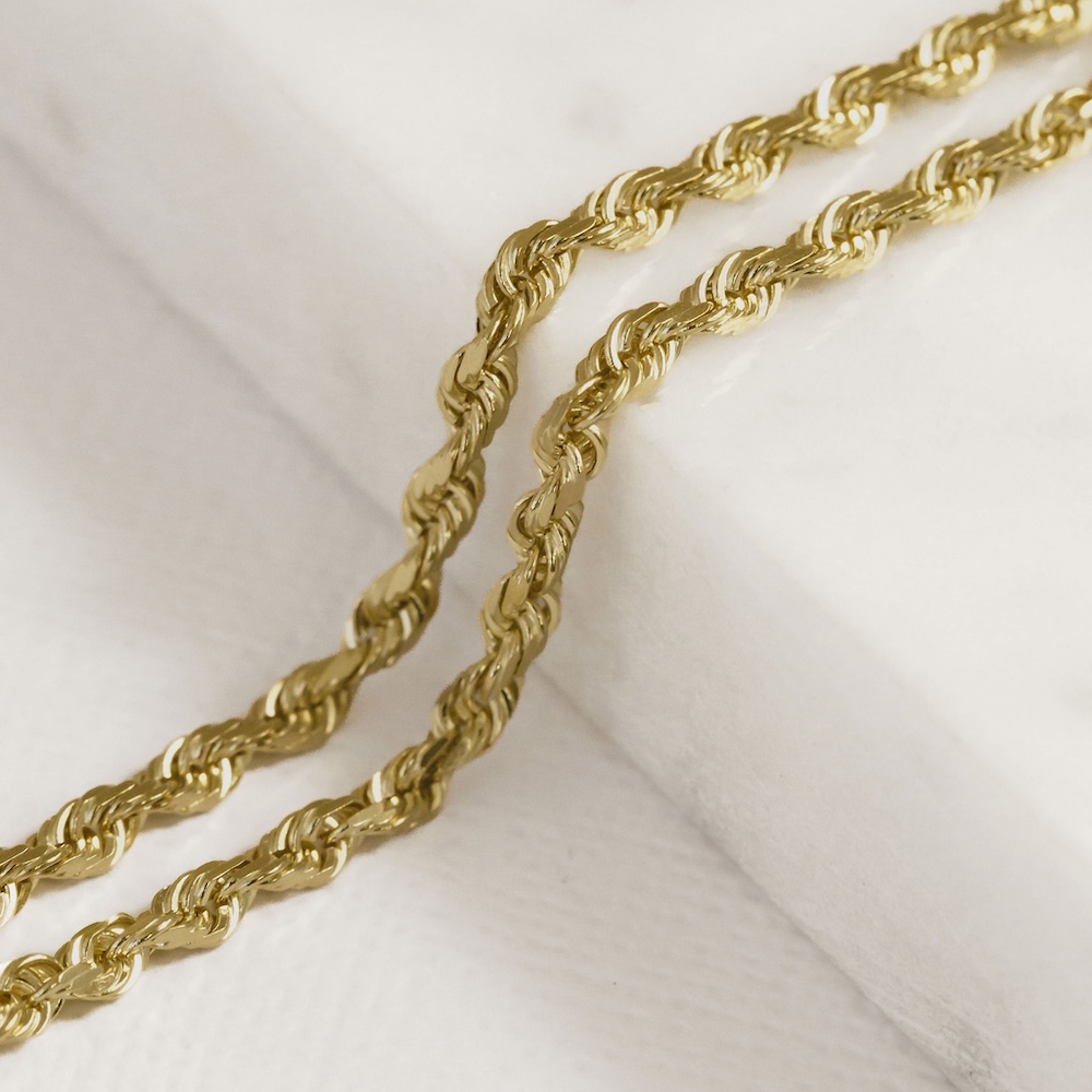 Solid rope chain necklace on a white surface.