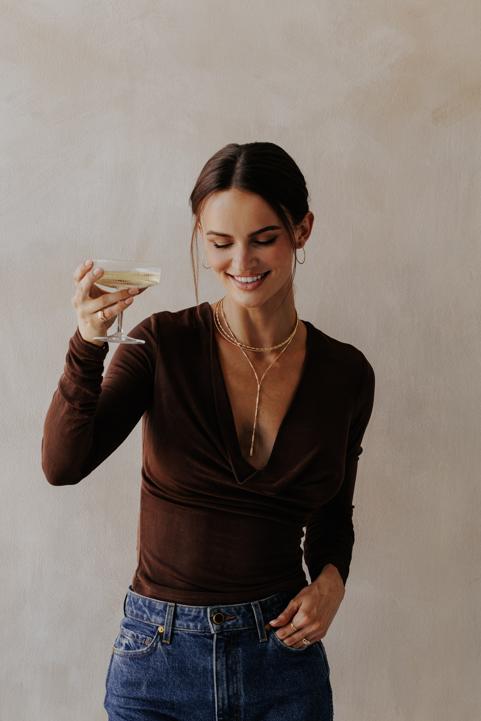 Model wearing multiple pieces from the gold edit.