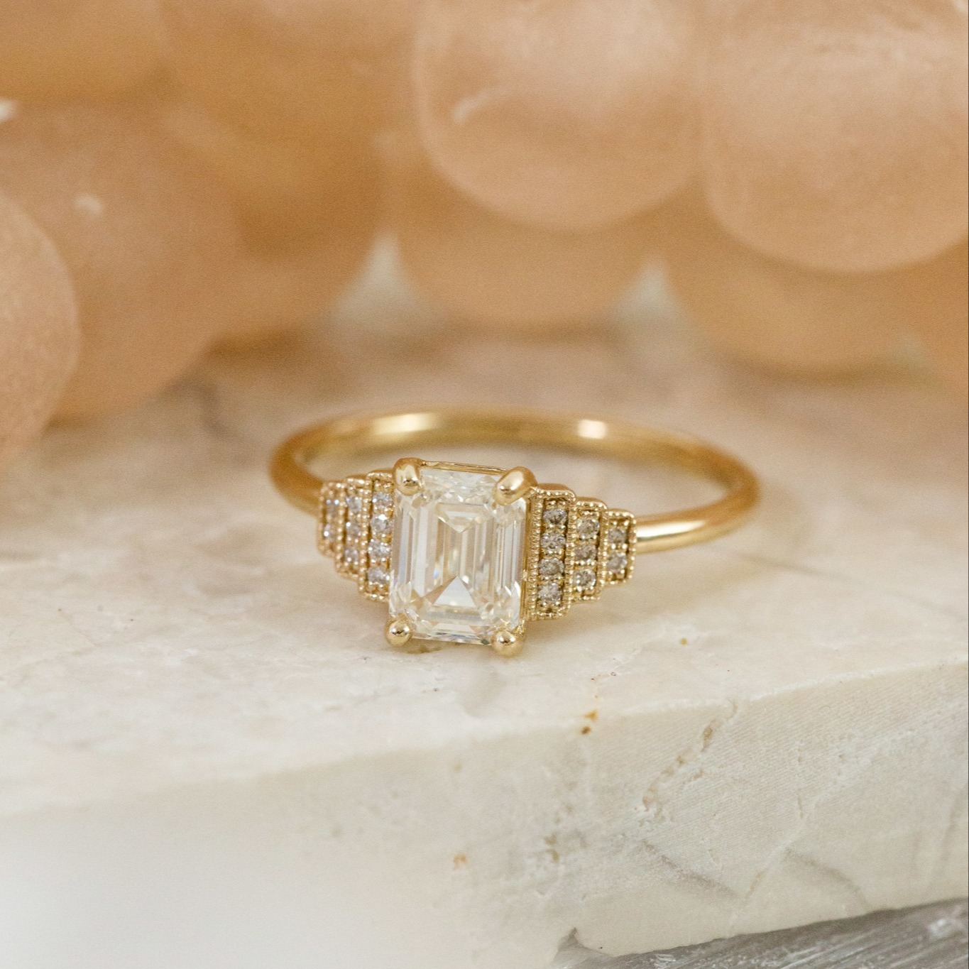 14k yellow gold emerald cut diamond engagement ring with  3 tiers of diamond side stones