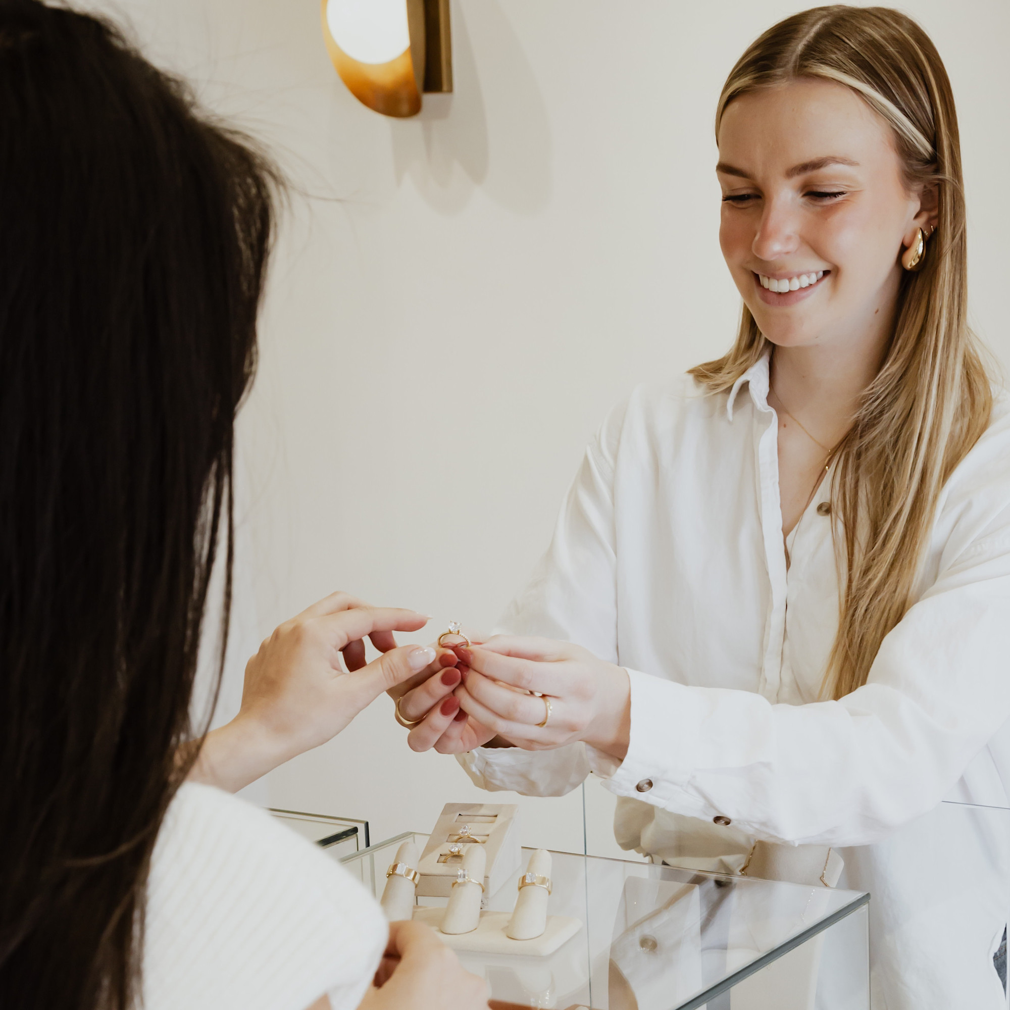 Sarah O. team member helping a woman shop for a diamond engagement ring.